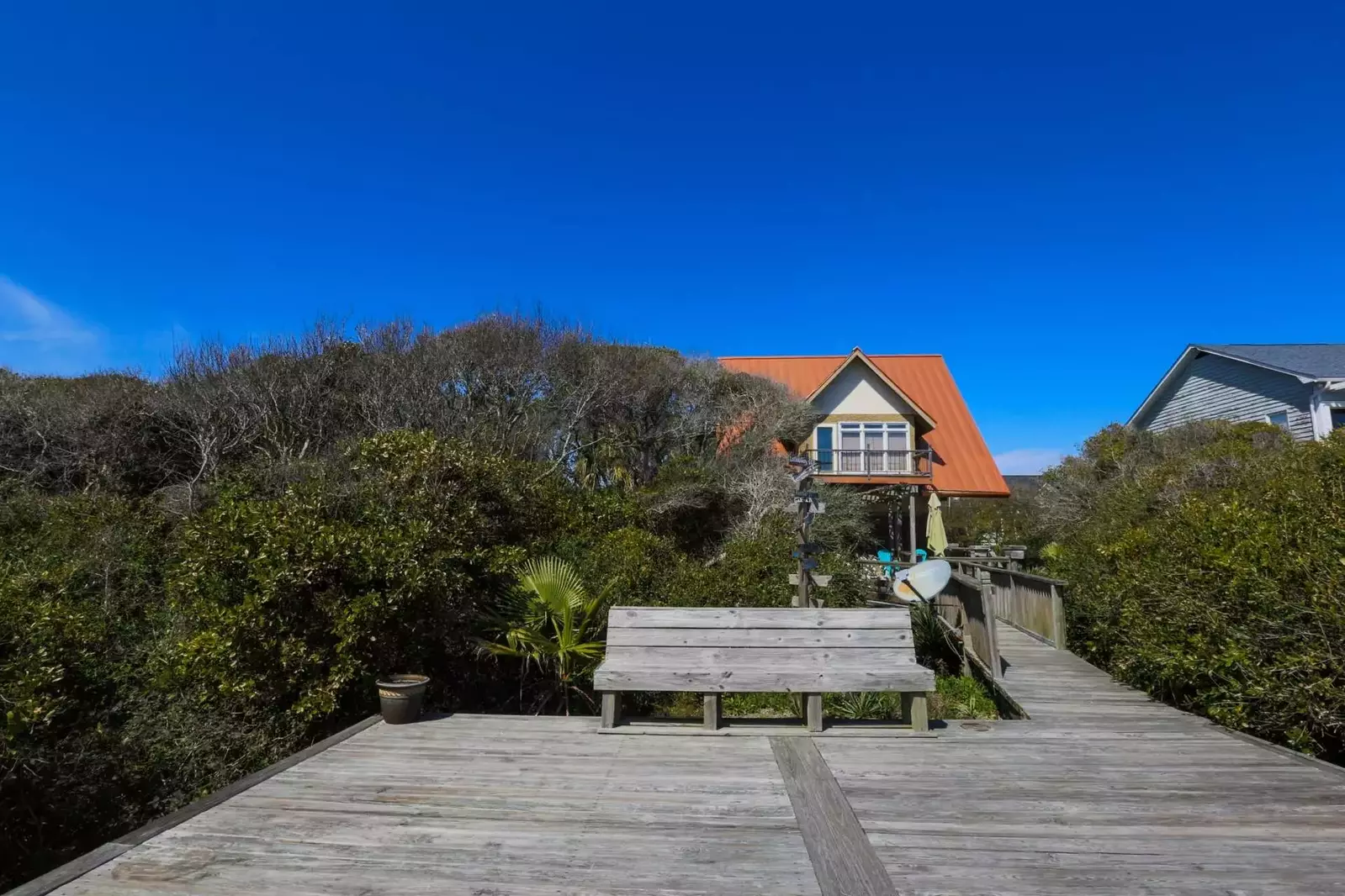 View of Someplace Else and its backyard deck from the boardwalk.