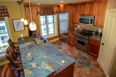 You'll love the kitchen's granite countertops, tiled backsplash and cork-lined walls.