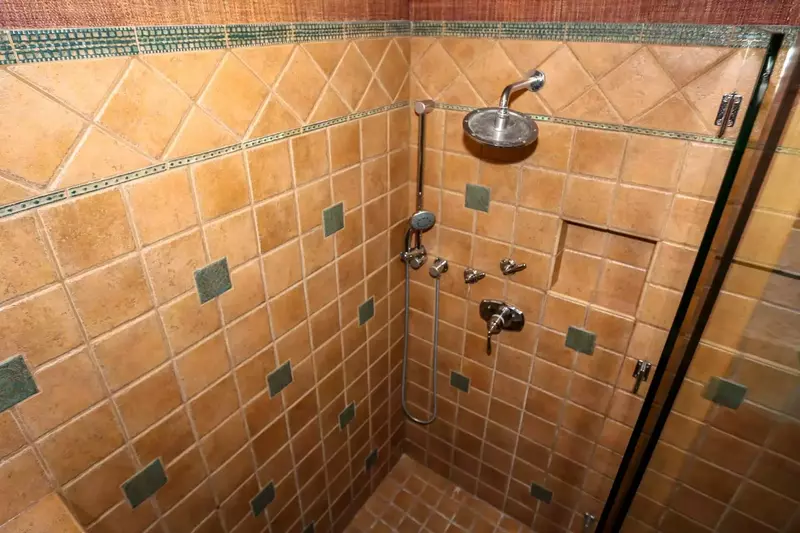 The tiled, walk-in shower in the master bathroom features two separate showerheads.