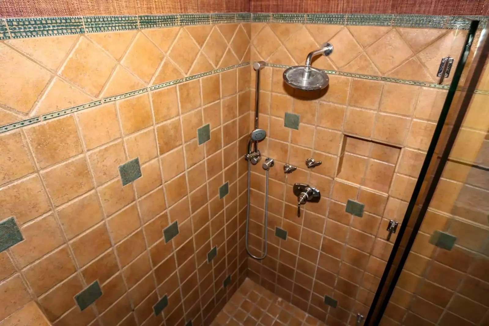 The tiled, walk-in shower in the master bathroom features two separate showerheads.