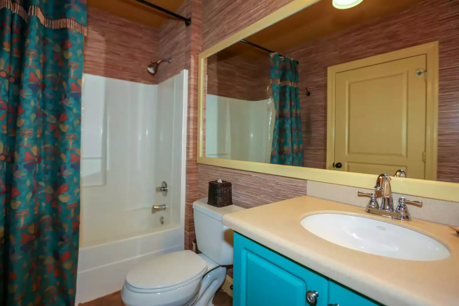 This guest bathroom contains a tub & shower, vanity and lots of space to store your personal belongings.