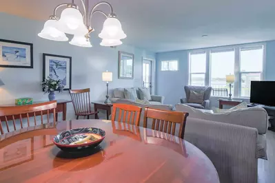 The dining table separates the living room from the kitchen.