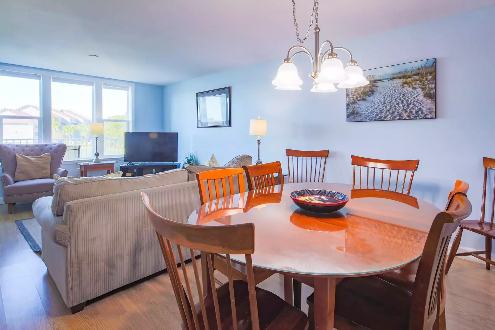 The dining table, which is located in between the kitchen & living room, seats 8.
