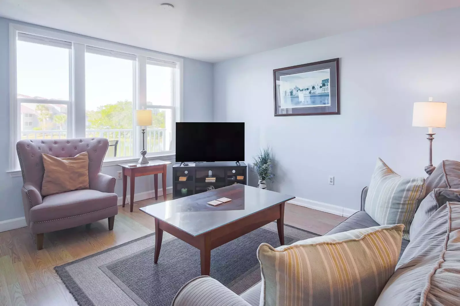 The living room features a large seating area and a smart TV.