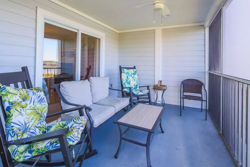 The screened porch features a spacious seating area.