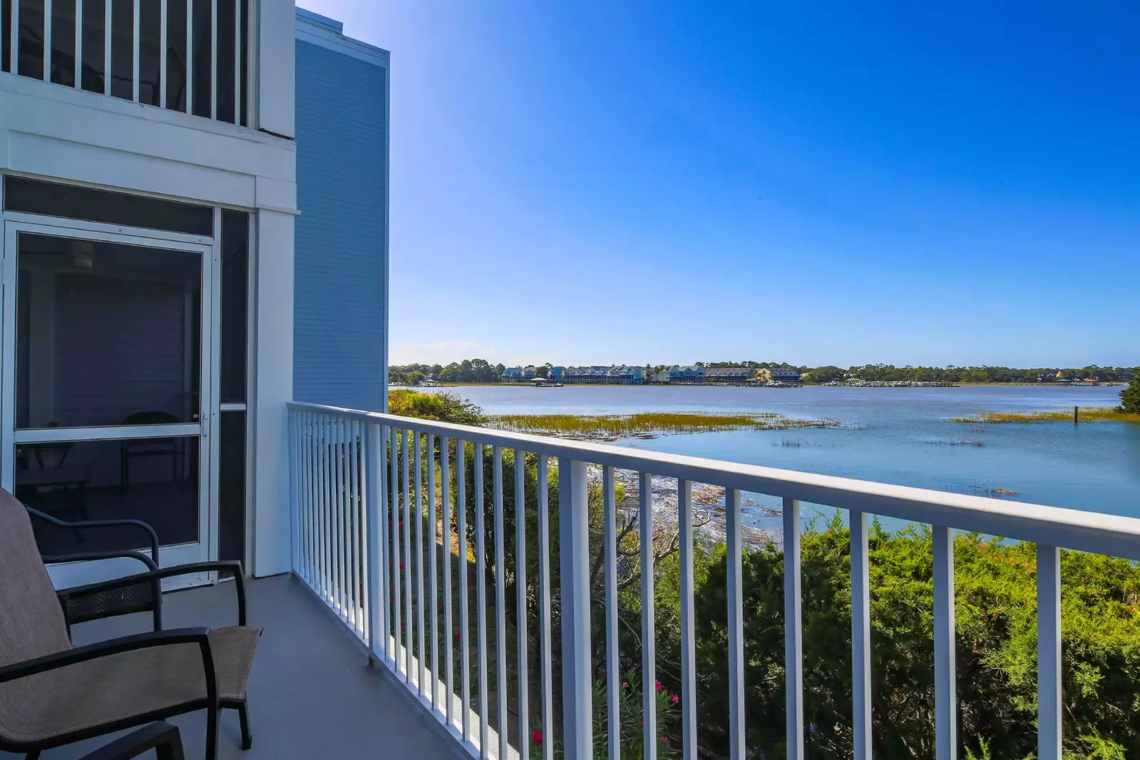The condo features both an open patio and a screened-in porch.