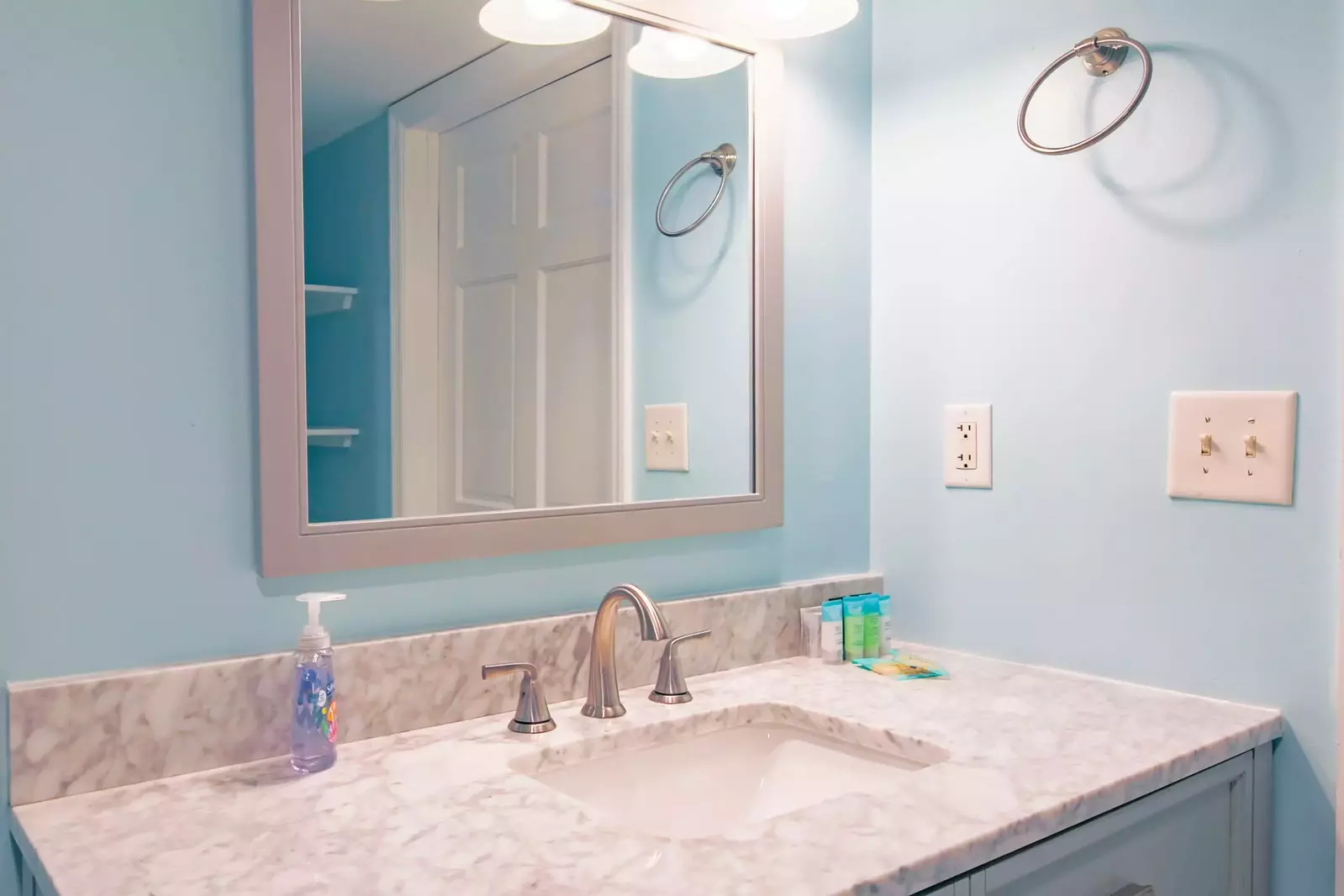 The renovated master bathroom features a spacious vanity.