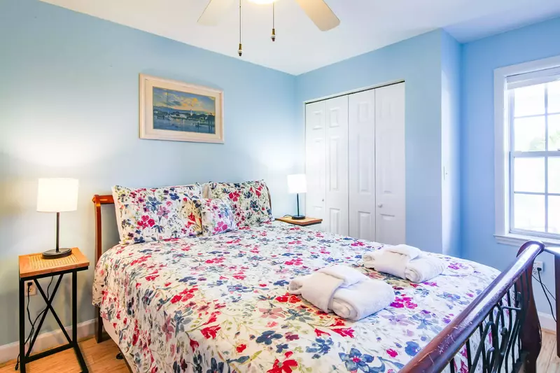The guest suite features a queen bed and night stands with reading lamps.