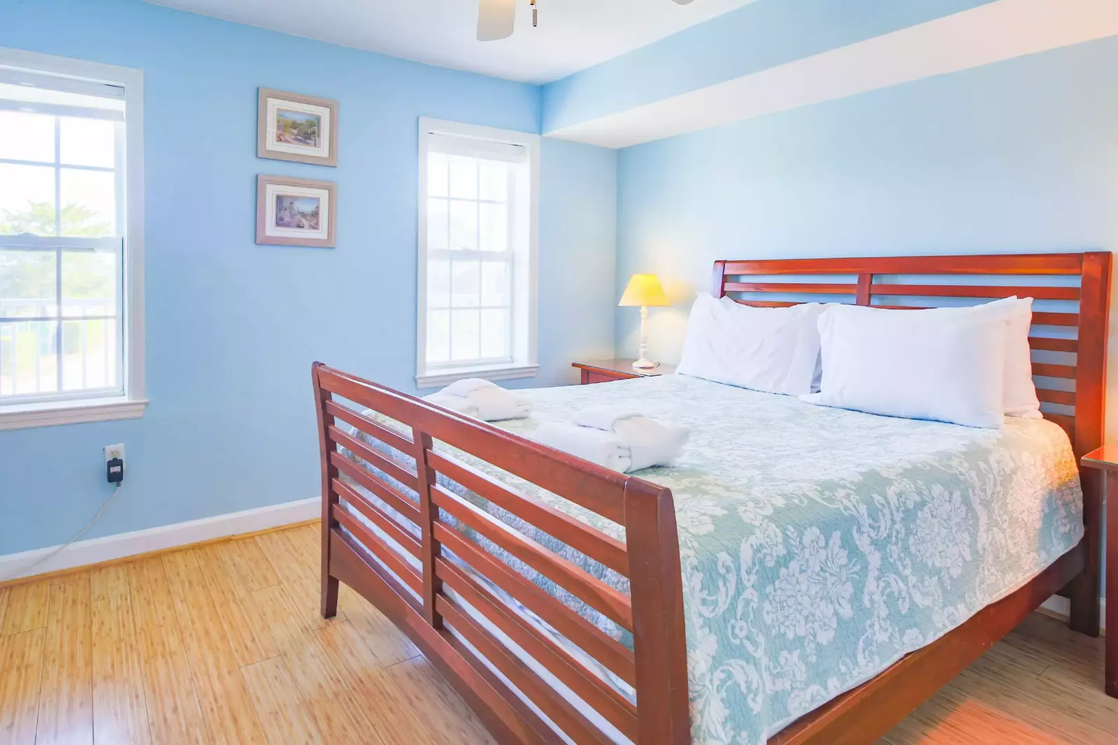 This guest bedroom receives lovely natural light through the two windows.