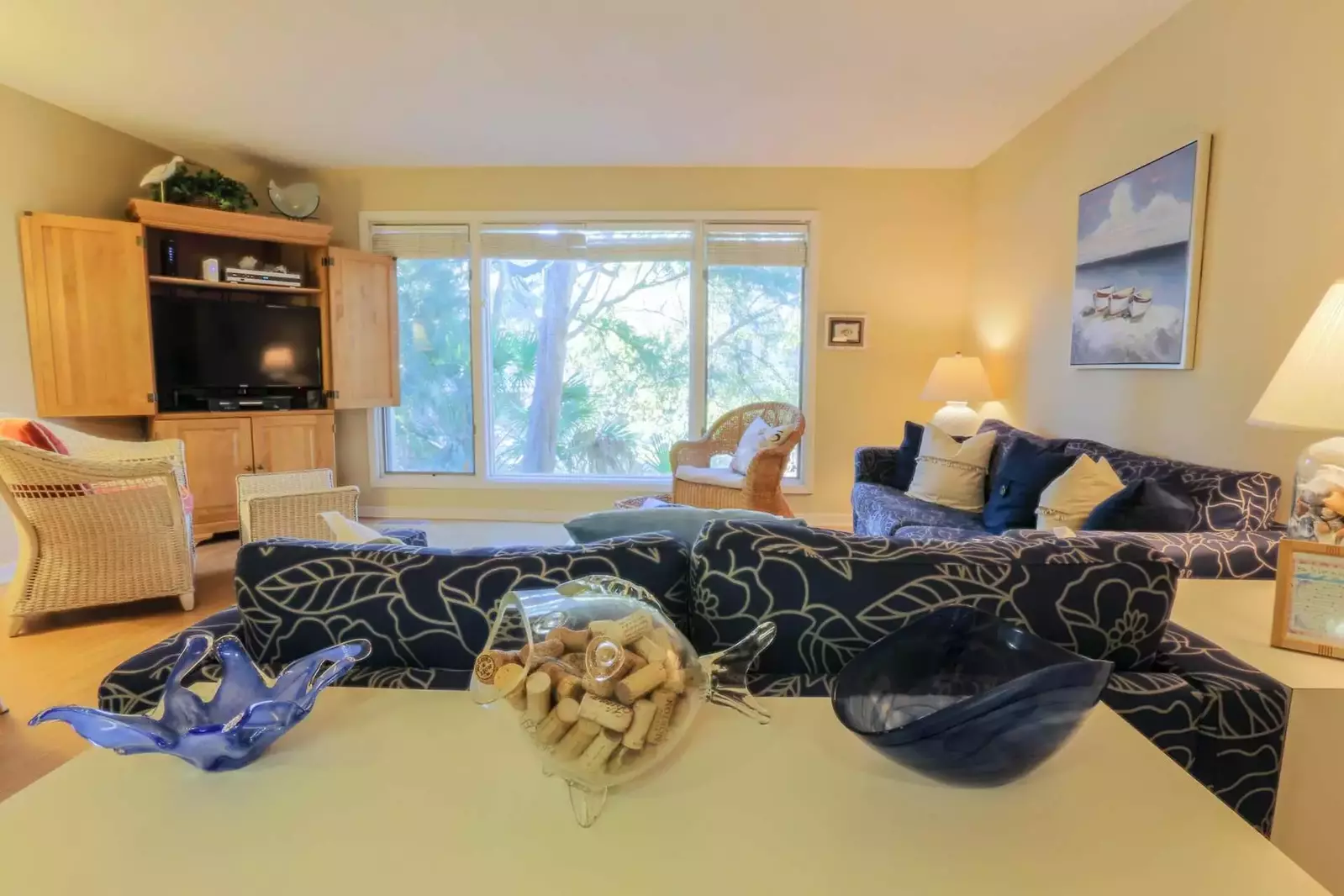 Relax and unwind in our natural light filled & beachy themed living room.