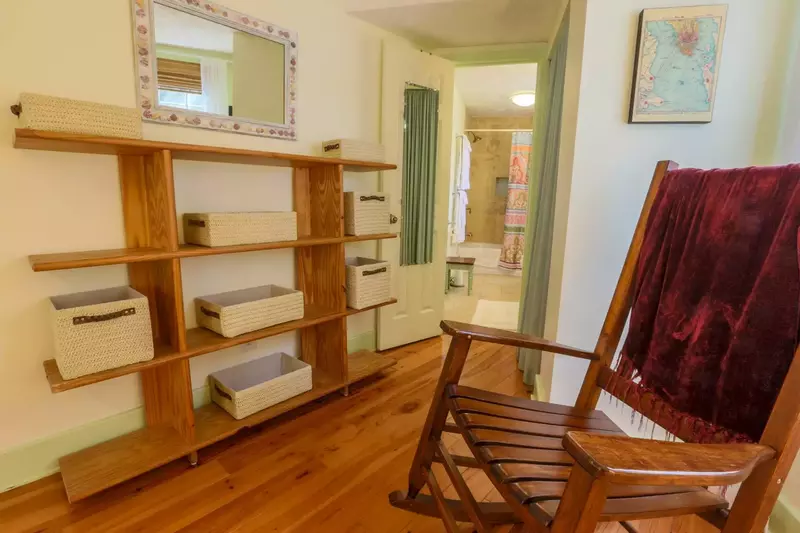 The master bedroom has shelves with baskets and a closet for storing your personal items.