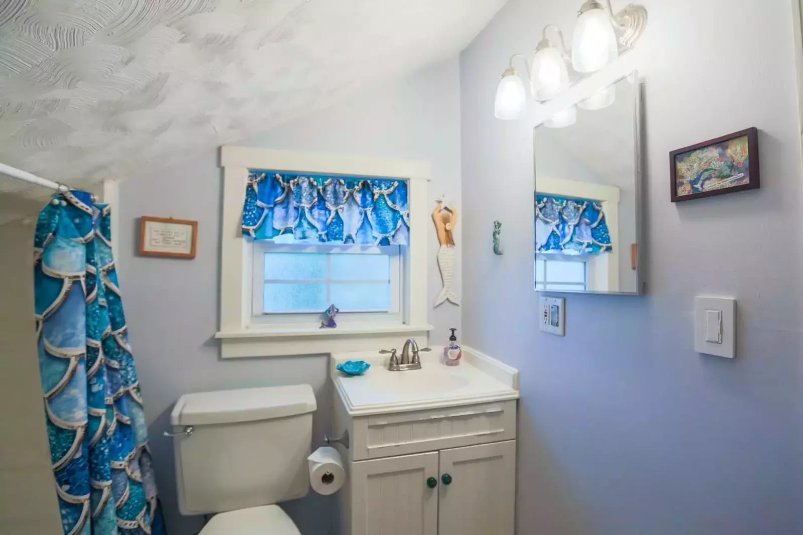 You'll love the mermaid theme touches in this upstairs half bathroom.  (There is no shower available in this bathroom.)
