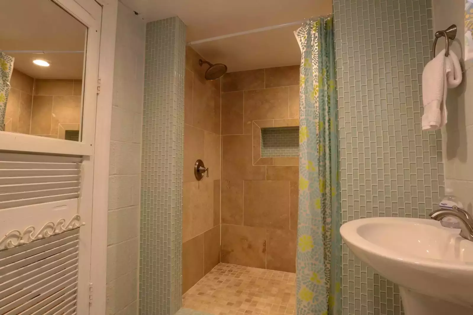 This beautifully tiled walk-in shower is located in the basement bathroom.
