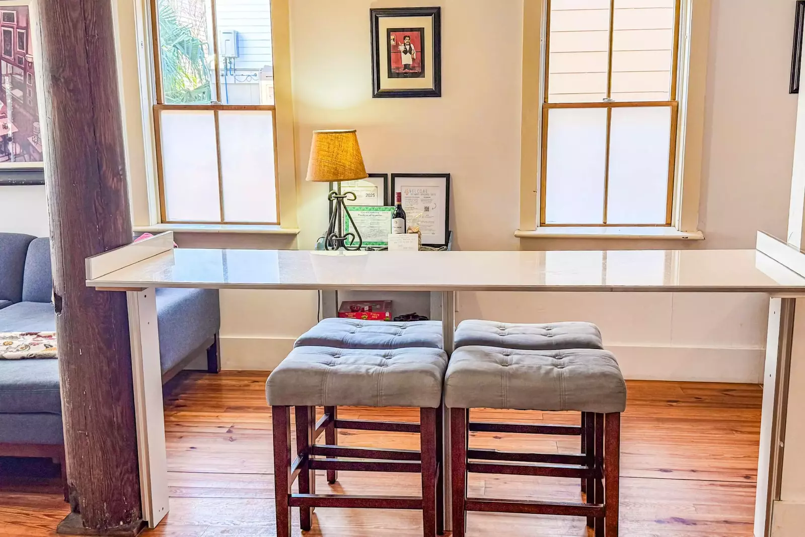 This high top counter with stool seating divides the living room from the kitchen area.