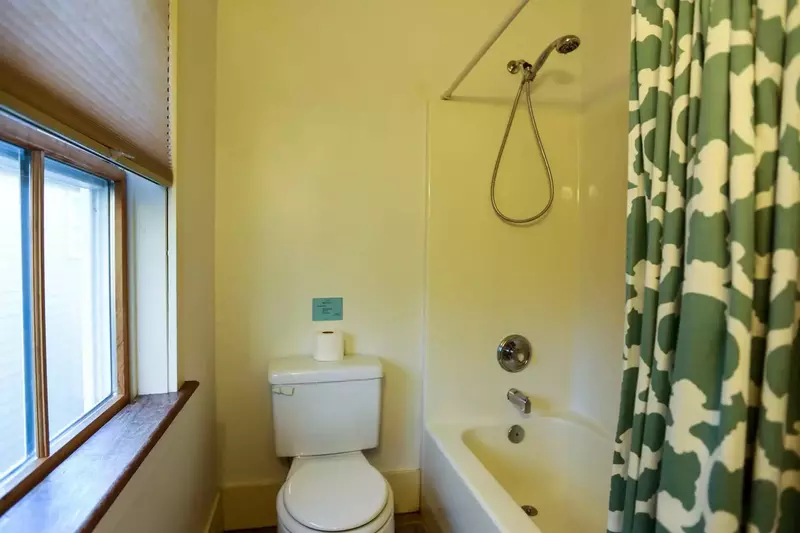 This en suite bathroom has a shower/tub combo.
