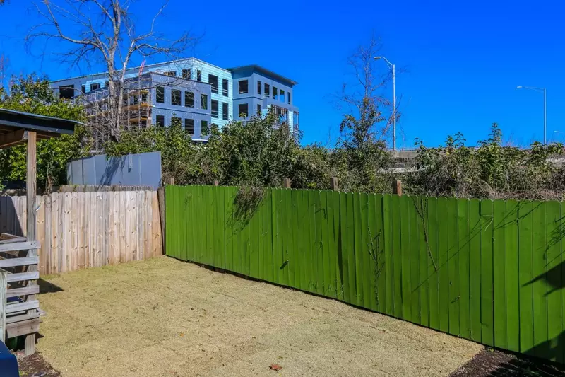 The Sweet Spacious Suite porch looks out onto this grassy backyard.