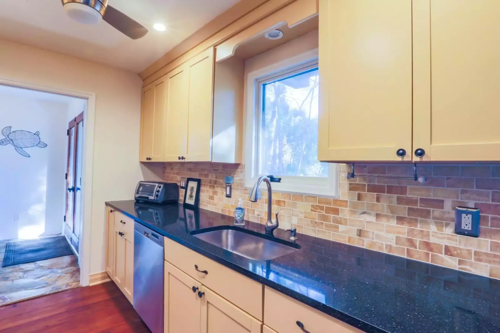 The window at the kitchen sink looks out onto the front of the home.