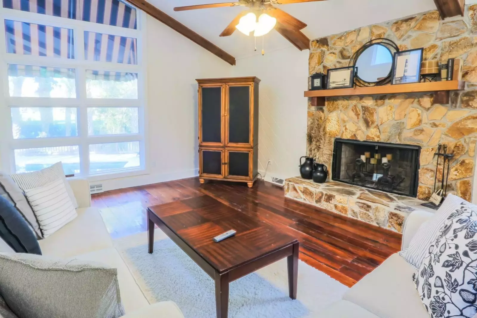 The living room is centered around a beautiful decorative fireplace.