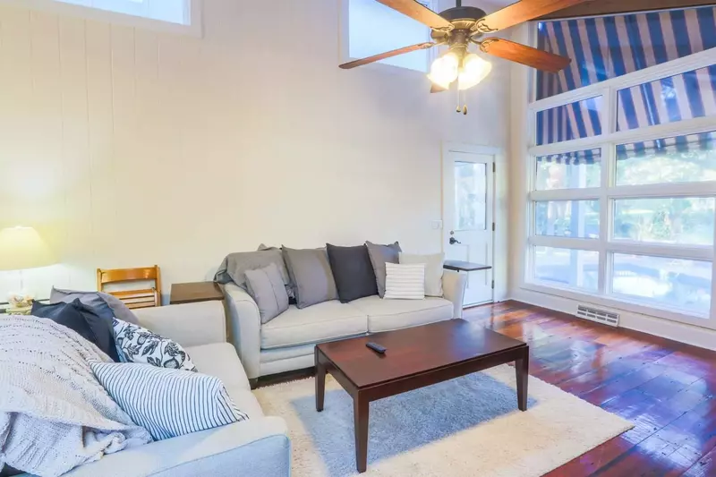 The living room looks out onto the pool, sundeck and backyard.