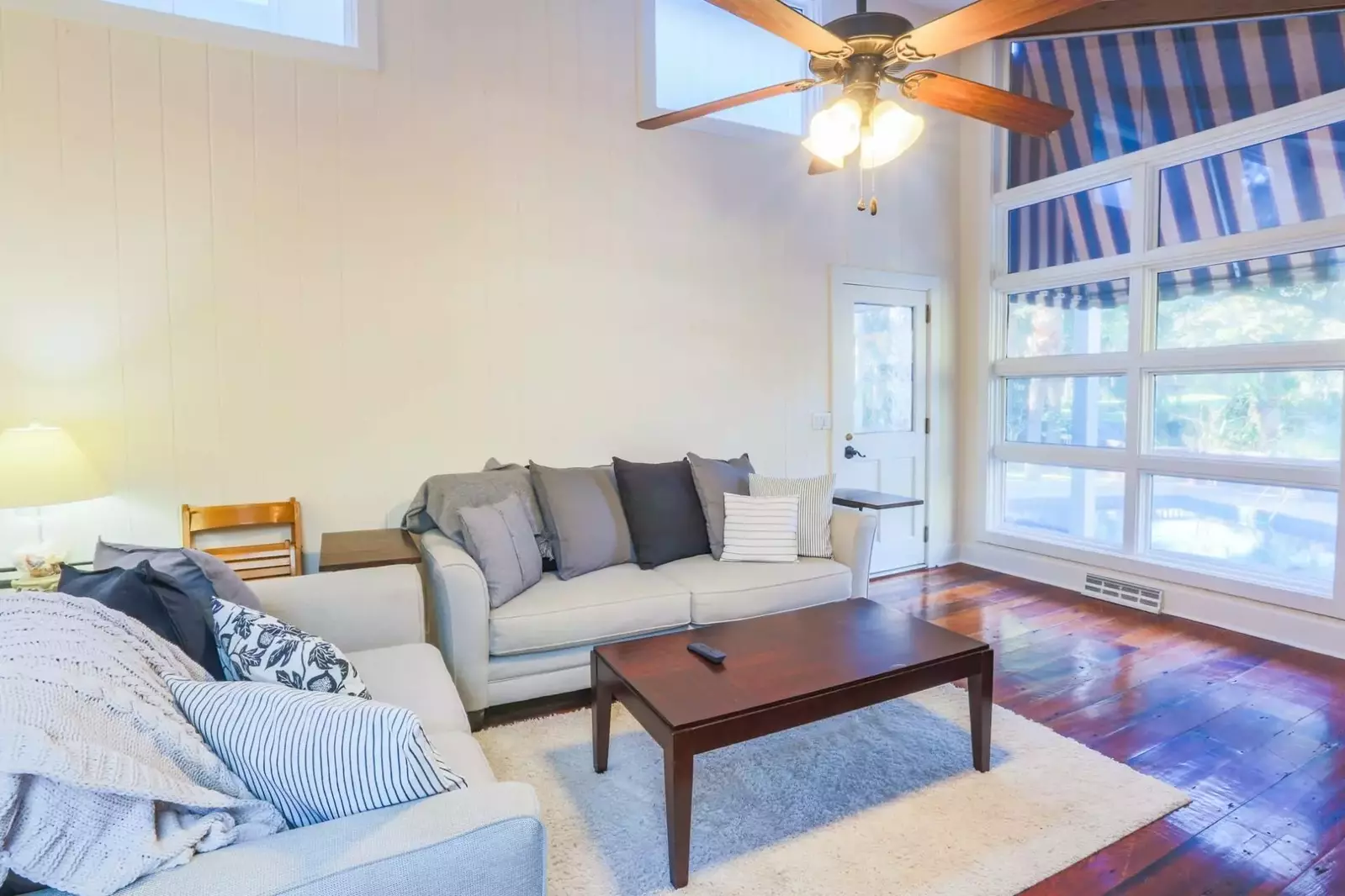 The living room looks out onto the pool, sundeck and backyard.