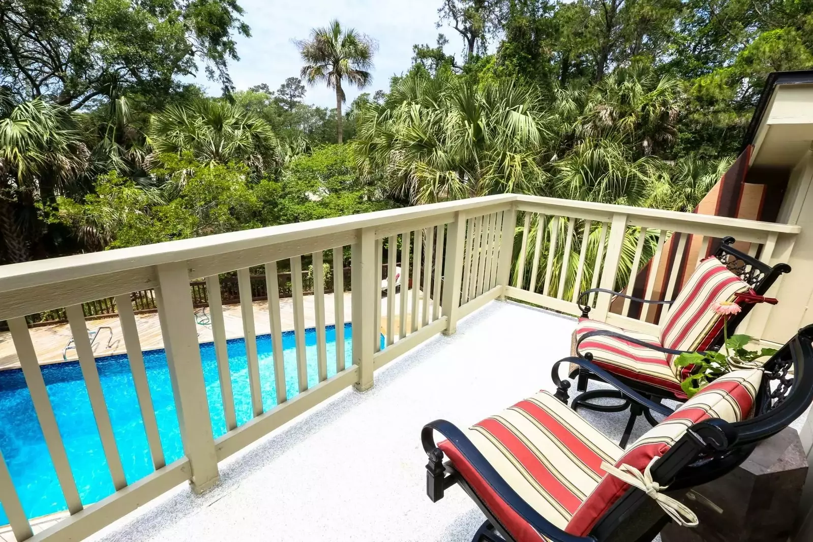 Enjoy a morning coffee or evening cocktail on the private balcony overlooking the pool.