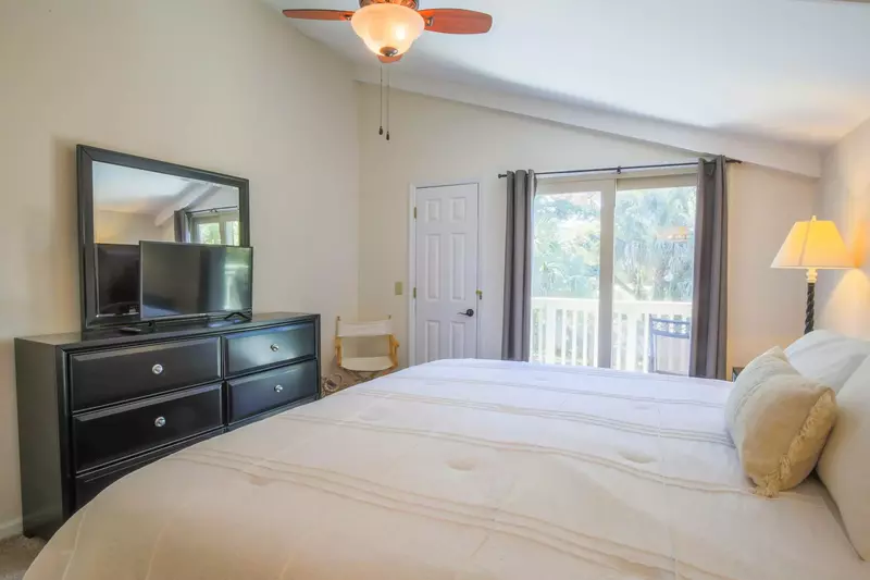 The master bedroom also features a dresser, smart TV and ceiling fan.