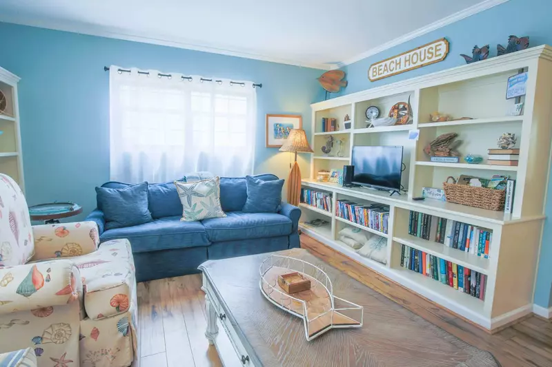 The living room is centered around this built-in bookcase with a smart TV.