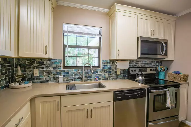The kitchen features all new cabinets, backsplash and counters.