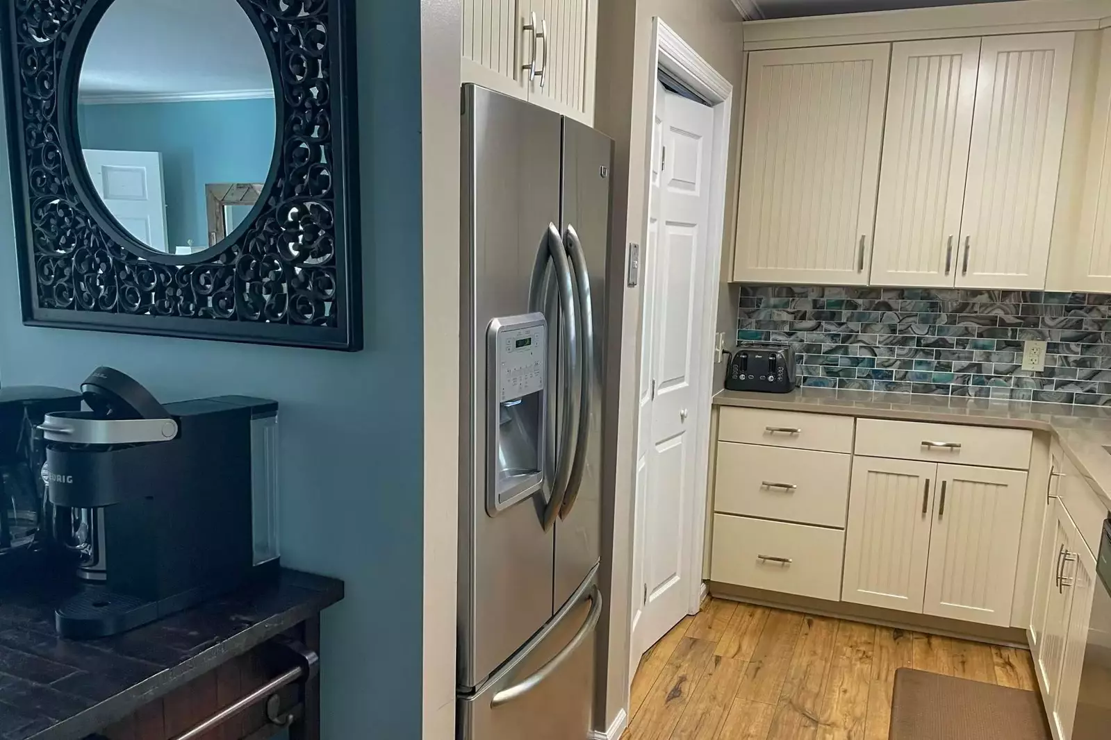 There is a full sized washing machine through the closet doors near the refrigerator.