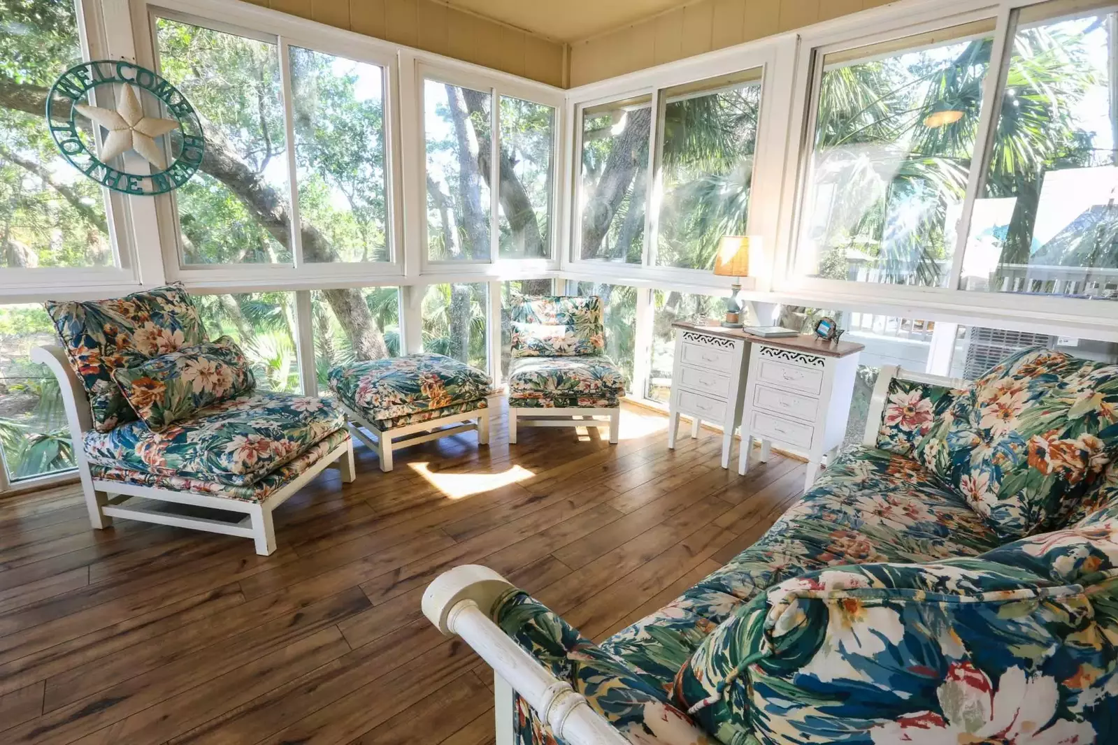 Sip your morning coffee and unwind in this light-filled solarium with sweeping views of the trees behind the house.