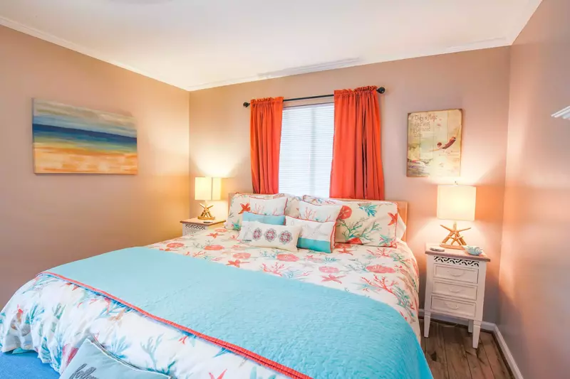The master suite features a king bed and starfish-themed beach decor.