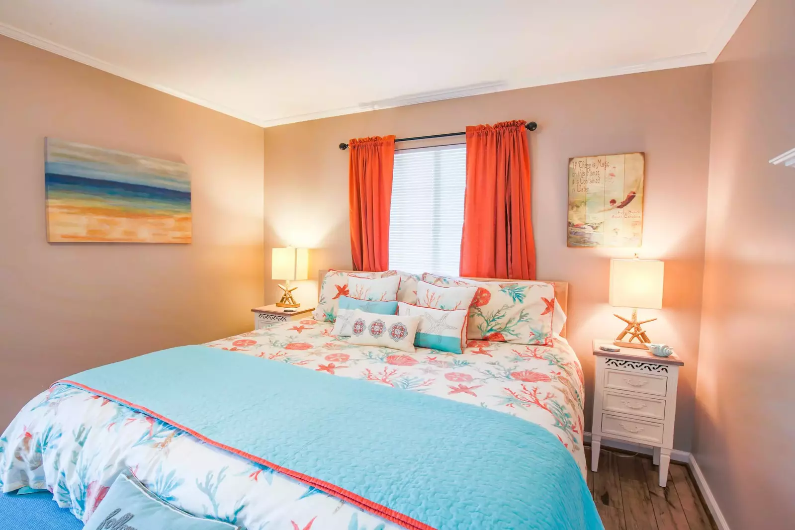 The master suite features a king bed and starfish-themed beach decor.