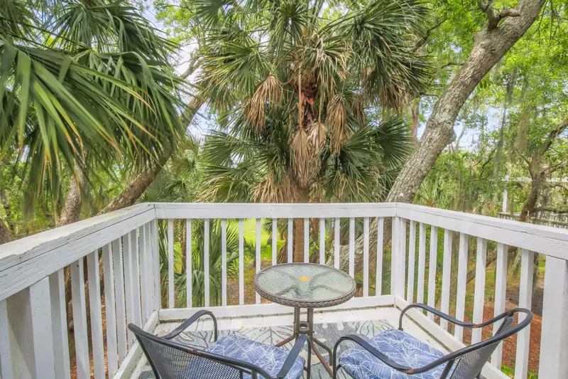 This private balcony off of the master suite overlooks the tree-filled backyard.