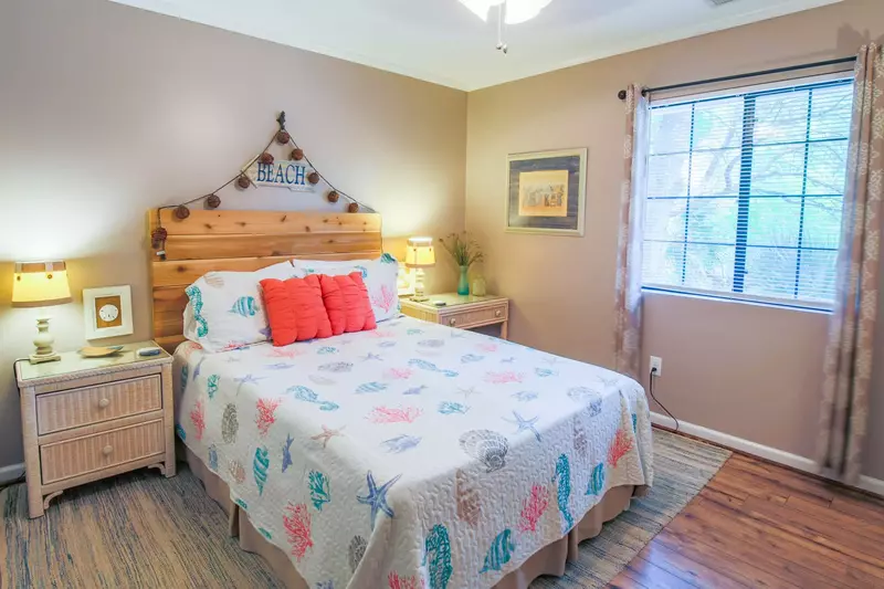 This guest bedroom features a queen bed and reading lamps on the nightstands.