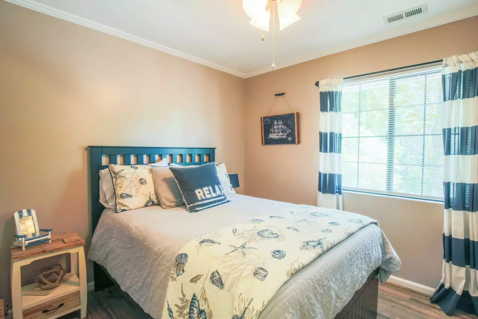 Sail away to dreamland in this guest bedroom with a nautical-themed full-sized bed.