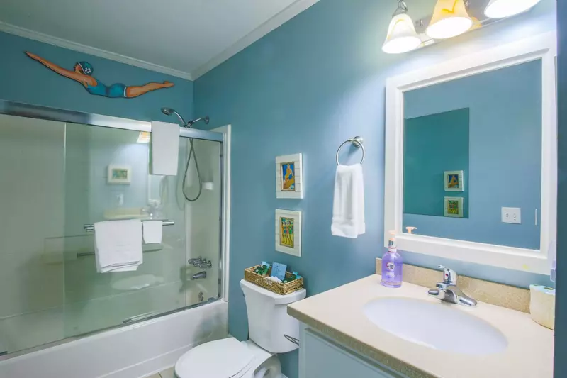 The bathtub and adjustable showerhead in the guest bathroom are perfect for bathing kiddos after a long day at the beach.