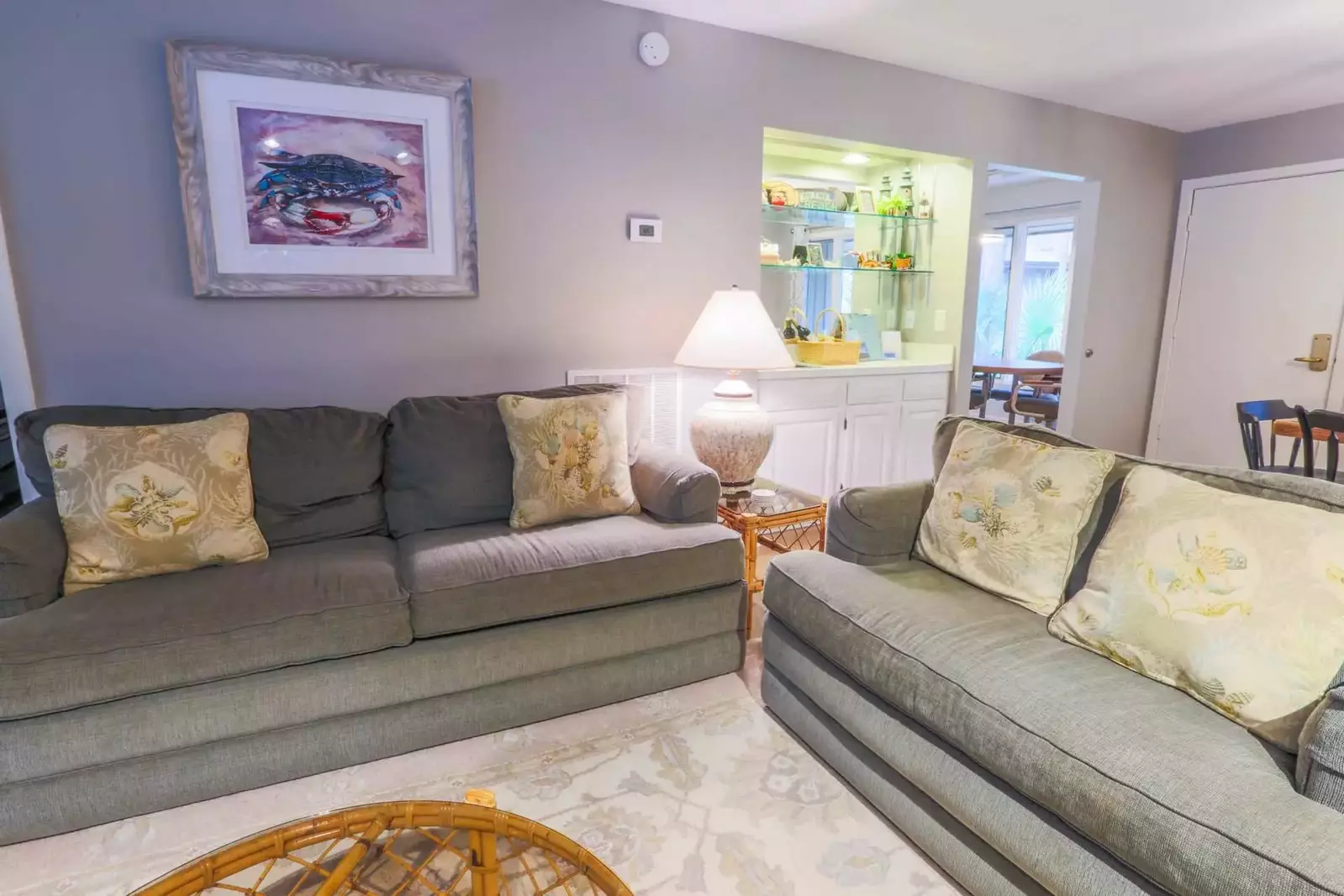 The living room features a seating area with two large sofas.