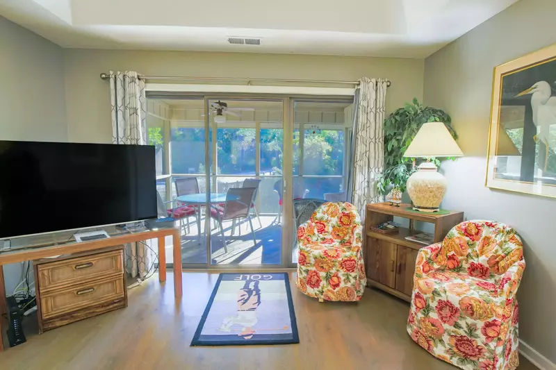 Enjoy a good book in the living room or on the screened-in porch.