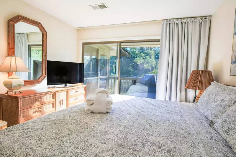 The master suite also features a dresser and streaming TV.
