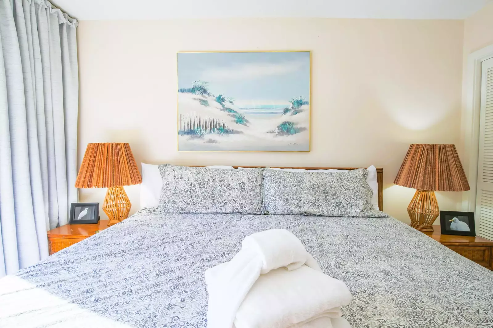 The kind bed in the master suite is flanked by two night stands with reading lamps.