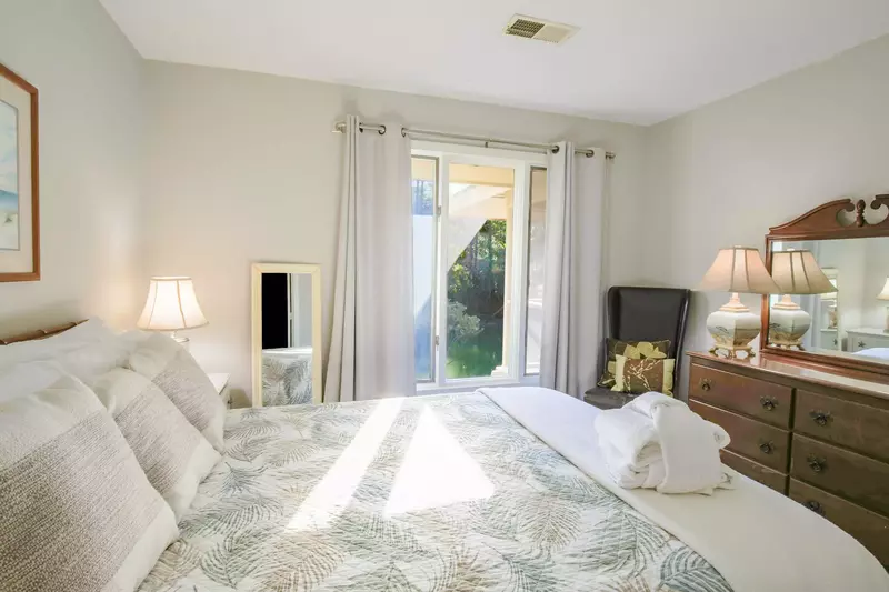 This guest bedroom enjoys lots of early morning light and a view over the tidal creek.
