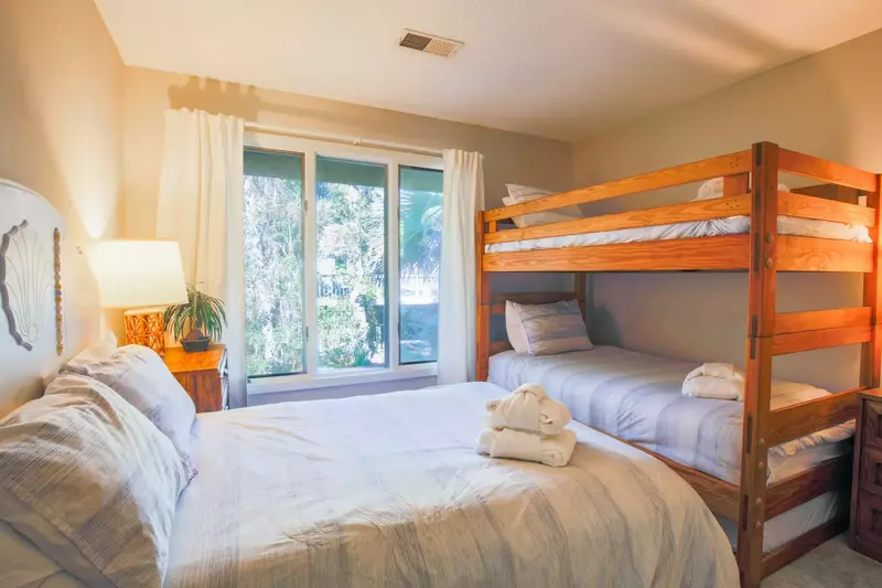 The bunk bedroom features a bunkbed with two twins and a full bed.