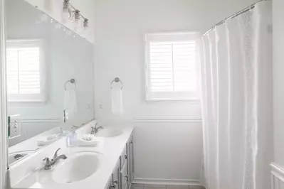 The master bath features dual vanities and a tub/shower combination.