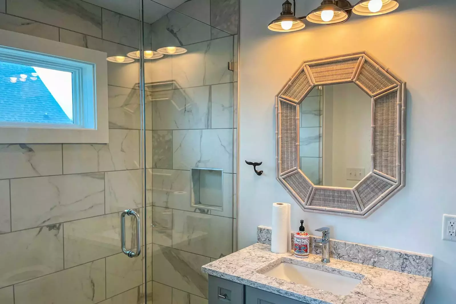 The master bathroom features a tiled, walk-in shower and a spacious vanity.