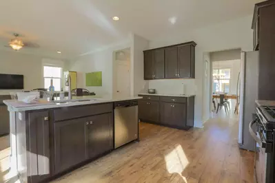 The open floor plan layout creates uninhibited views of the living room and dining room from the kitchen.