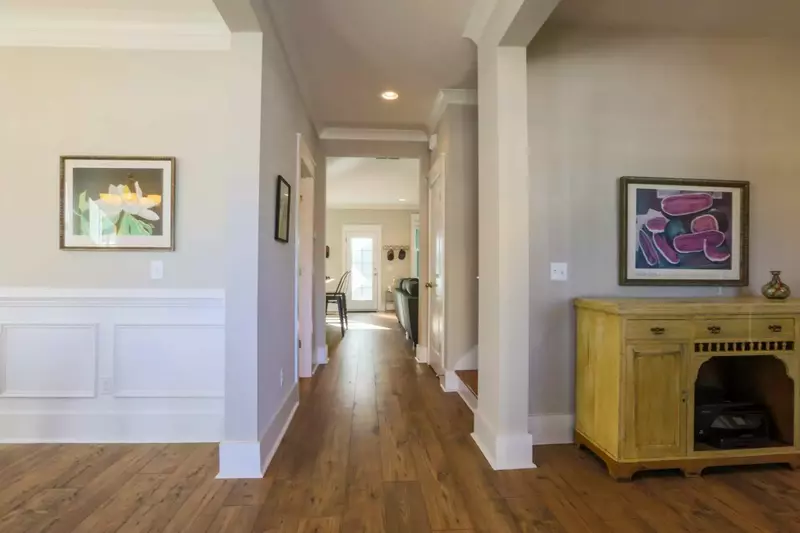 The front door opens on to a central hallway that leads to the kitchen and living room.