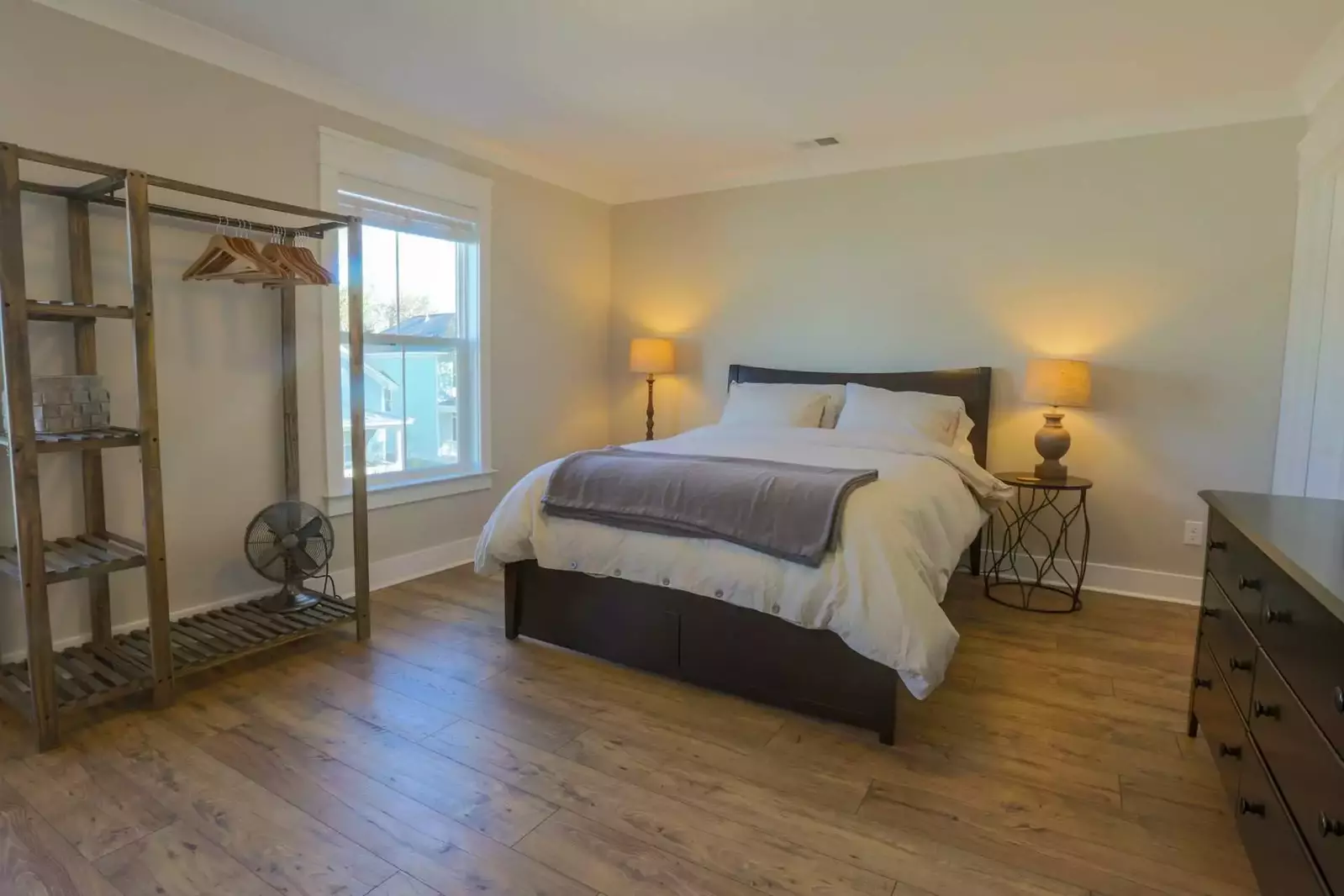 The master suite features a queen-sized bed, dresser, nightstands, reading lamps and en suite bathroom.