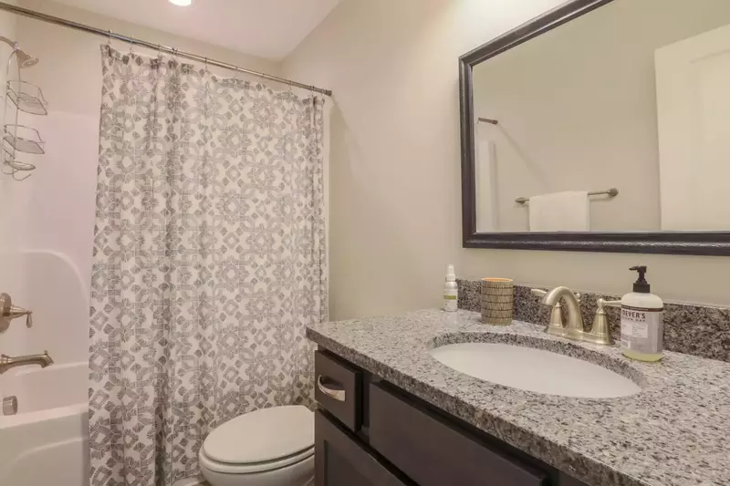 There's a bathroom off the second floor hallway with a combined shower & tub, vanity & toilet.