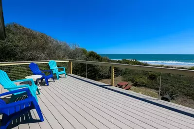 The private deck has stunning views of the backyard, sand dunes, beach & Atlantic ocean.