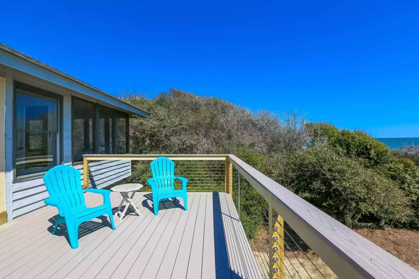 Both sides of the home are surrounded by natural barriers of trees & shrubs.
